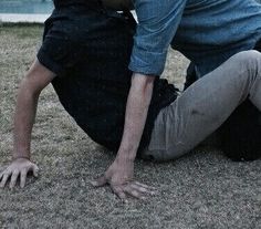 a man is kneeling down on the grass