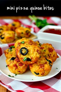 mini pizzas with cheese and olives on a plate