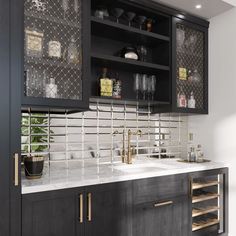 a kitchen with black cabinets and white marble counter tops, gold accents on the backsplash