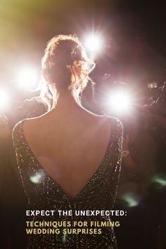 the back of a woman's dress with lights shining on her head and shoulders