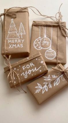 four brown bags with christmas ornaments on them