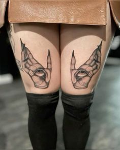 woman's legs with black and white tattoos on them