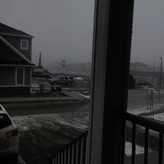 a car parked in front of a house on a snowy day