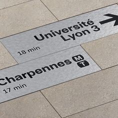 two street signs on the ground pointing in opposite directions