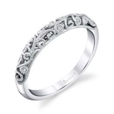 a white gold wedding band with an intricate design on the top and bottom, set with diamonds