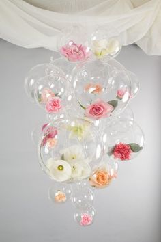 a bunch of balloons that have flowers in them