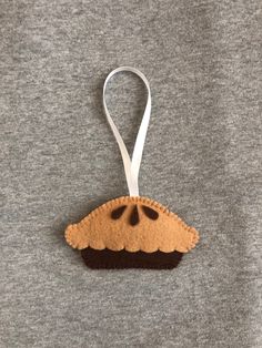 an ornament shaped like a slice of pie hanging on a t - shirt