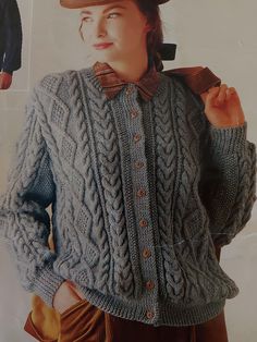 an old photo of a woman wearing a sweater and hat