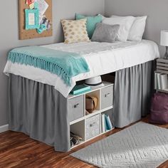 a bedroom with a bed, rugs and pictures on the wall above it is shown