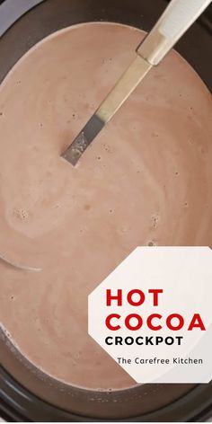 hot cocoa crockpot in a slow cooker with a spatula on top