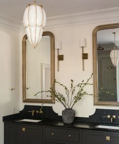 a bathroom with two sinks and mirrors on the wall