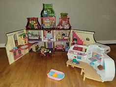 a doll house with lots of furniture and accessories on the floor in front of a wall