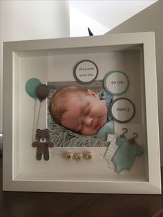 a baby's photo in a shadow box frame