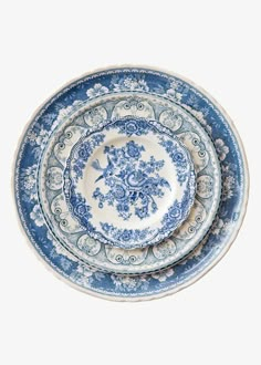 three blue and white plates stacked on top of each other in the shape of flowers