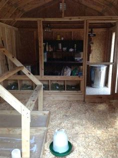 the inside of a chicken coop with stairs leading up to it's door and storage area