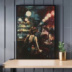 two women sitting at a bar in front of a painting on the wall next to a potted plant