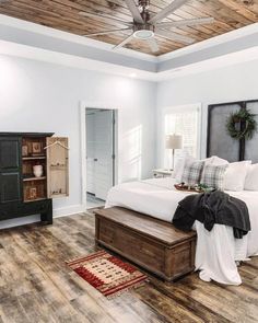 a bedroom with wood floors and white walls