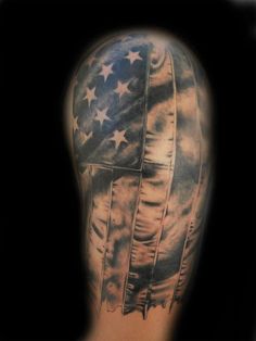 the back of a man's arm with an american flag tattoo design on it