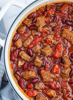 a large pot filled with meat and beans