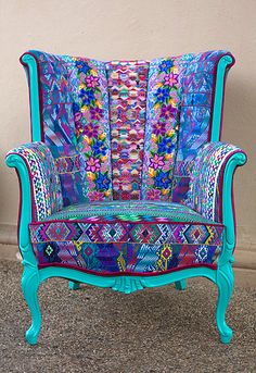 a colorful chair sitting in front of a wall