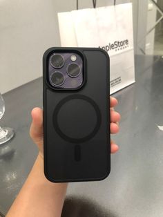 a person holding up an iphone case with the camera on it