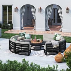 an outdoor living area with couches, tables and potted plants