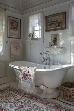 a white bath tub sitting in a bathroom next to a rug and window with curtains