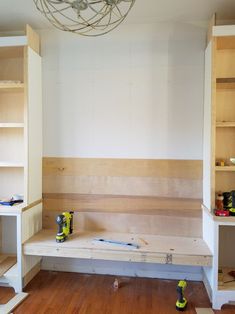 an unfinished room with shelves and tools on the floor