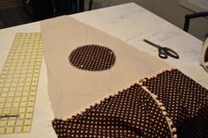 sewing supplies are laid out on the table to be sewn and stitched together