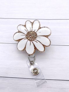 "This cute flower badge reel can be changed out with different toppers to fit each holiday or mood. It is the perfect addition to add a bit of sparkle to your badge reel.  This also makes a great gift for healthcare workers, education staff and anyone else that has to wear a badge. DETAILS: -2\" badge -Topper can be attached permanently or interchangeable using Dual Lock Velcro.  This ensures that it is sturdy while also easy to clean (especially for our healthcare workers!) -Hand glittered and Adjustable White Badge Holder As A Gift, Cute White Badge Holders For Gift, Cute White Badge Holders For Gifts, Cute Personalized Badge Reel For Gifts, Cute White Badge Reel For Gift, Personalized White Badge Reel As Gift, Playful White Badge Reel As Gift, Cheap Cute Personalized Badge Reel, Cute Personalized White Badge Reel