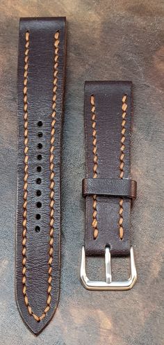 Enhance your timepiece with our meticulously crafted dark brown Wickett & Craig vegetable tanned bridle leather watch strap. Hand-stitched with precision using durable amber glow thread, this strap is more than just an accessory - it's a statement of timeless style and superior craftsmanship. With a versatile 20mm lug width and a durable stainless steel clasp, this strap ensures a secure and comfortable fit for your wrist. Its rich, dark brown hue complements a variety of watch faces and outfits Vintage Brown Watch Bands For Business, Classic Vintage Brown Watch Bands, Classic Watch Bands In Vintage Brown For Everyday Use, Classic Vintage Brown Watch Band For Everyday Use, Classic Vintage Brown Watch Bands For Everyday Use, Business Brown Leather Watch Bands, Handmade Brown Watch Accessories For Everyday Use, Vintage Brown Leather Watch Accessories For Everyday Use, Classic Brown Leather Watch Bands