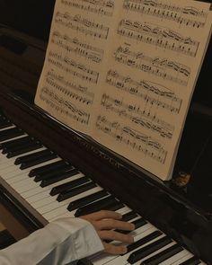 someone playing the piano with sheet music on it