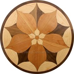 a circular wooden table top with an abstract design