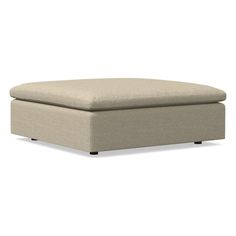 a beige ottoman that is sitting on the ground