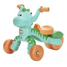 a green and orange toy dinosaur riding a tricycle