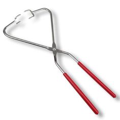 a pair of tongs sitting on top of a metal holder with two red handles