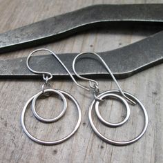 I have been having fun with stainless steel earrings lately and here is another pair. These are 1.5" in total length and have a titanium ear wire. These are completely hypoallergenic earrings. The circle shaped connectors are perfect for a minimalist look. These will not tarnish or change over time. The largest circle link is 20mm in size, the small one is 12mm. These are smooth and exactly the same front and back. The jump rings are also stainless steel.  If you love the look but would prefer longer, please reach out to me about availability and what you would like. I am happy to make something perfect for you. To find all the stainless steel options in my shop start here, https://www.etsy.com/shop/CraftLikeAnArtist?search_query=stainless+steel Nickel Free Stainless Steel Drop Earrings, Hypoallergenic Circular Earrings For Everyday, Everyday Silver Stainless Steel Earrings, Small Hoop Earrings In Surgical Steel As Gift, Everyday Pierced Earrings In Surgical Steel, Everyday Pierced Surgical Steel Earrings, Nickel Free Surgical Steel Minimalist Hoop Earrings, Everyday Surgical Steel Earrings, Simple Nickel-free Earrings For Anniversary