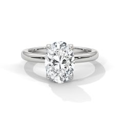 The Tulip Setting, a mesmerizing solitaire ring that combines elegance with intricate detail. This setting features diamond-adorned petal prongs underneath the center stone, adding a subtle yet dazzling touch to the ring. Each diamond on the prongs enhances the brilliance and beauty of the central diamond, creating a floral-inspired design that captures attention from every angle. Perfect for those who appreciate fine craftsmanship and unique embellishments, The Tulip Setting is a symbol of refi 14k White Gold Solitaire Diamond Ring, Silver Oval Diamond Ring With Single Diamond, Oval Silver Diamond Ring With Single Diamond, Oval Single Diamond Platinum Ring, White Gold Oval Ring With Lab Grown Diamond, Oval White Gold Ring With Lab Grown Diamond, Oval Platinum Diamond Ring With Single Diamond, Diamond White Oval Solitaire Ring, White Diamond Solitaire Ring