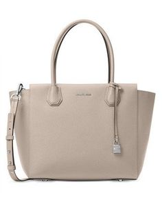 Classic sophistication translates into practical polish with spacious Mercer satchel. Made from luxuriously textured pebble leather, the Mercer can be worn on your arm by its double handles, or as a crossbody or shoulder bag by its long, slim detachable strap.Pebble leather; lining: polyesterLarge sized bag; 17-1/2"W x 11"H x 6-1/2"D7-1/2"L double handles; 17"L-19-1/2"L adjustable and detachable strapTop-zip closureExterior logo, feet and lock charm1 interior zip pocket and 1 slip pocketLaptop c Sac Michael Kors, Michael Kors Mercer, Michael Kors Handbag, Michael Kors Outlet, Bags Michael Kors, Leather Satchel Bag, Pearl Grey, Satchel Handbags, Handbags Michael Kors