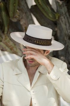 BOLERO is a handcrafted piece in the classic shape of the Cordobes in Ivory tone, with a slightly curled brim and details to be appreciated by yourself. - Natural cotton brown band wrapped around the crown. - Beautiful pheasant feather hand stitched on the band. - Natural goat leather sweatband. 58 cm Elegant Cream Panama Hat With Flat Crown, Luxury High Crown Adjustable Hat Bands, Elegant Flat Brim Hat Band For Country Events, Elegant Cream Fedora With Flat Crown, Elegant Brown Hat Bands For Rodeo, Elegant Hat Bands For Rodeo With Flat Crown, Elegant Fur Felt Hats For Western-themed Events, Elegant Beige Felt Hat With Flat Crown, Elegant Beige Flat Crown Felt Hat