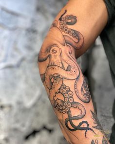 an octopus tattoo on the arm of a man