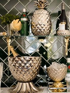 the shelves are filled with different types of wine bottles and glasses, including pineapples