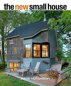 a small house with a deck and chairs on the front porch, surrounded by trees