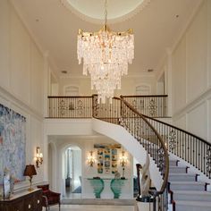 an elegant foyer with chandelier and art work