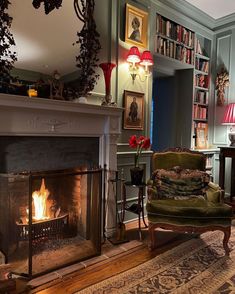 a living room filled with furniture and a fire place next to a book shelf full of books