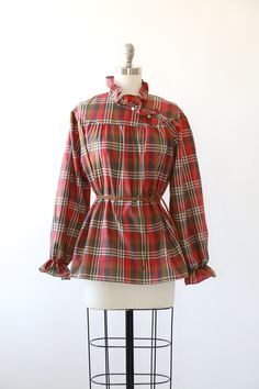 "Vintage 1970s Fall plaid blouse High neck ruffle neck + puff ruffle sleeves Great vintage condition M e a s u r e m e n t s: Size: fits like a M L BUST: 23\" Waist: 24\" Total length: 27 1/2\" Sleeves: 23\" Label: Lucky winner +All Measurements are taking while garment is lying flat+ + Jewelry, belts, and any other accessories are NOT included unless specifically stated in description+ i n s t a g r a m: cali_vintage_usa" Fitted Plaid Blouse For Fall, Plaid Ruffled Blouse For Work, Plaid Ruffle Blouse For Work, Vintage Plaid Long Sleeve Tops, Fall Daywear Plaid Blouse, Plaid Long Sleeve Blouse With Ruffles, Fall Plaid Top With Ruffles, Fall Plaid Ruffled Tops, Plaid Blouse For Daywear In Fall