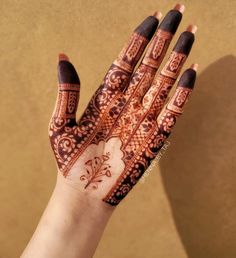 a woman's hand with henna on it