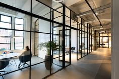 an office with glass walls and lots of windows