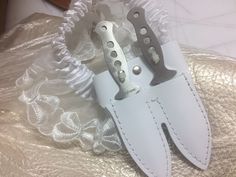 "**Notes** We have recently updated the knives to have heart shaped holes in the handle, same dimensions. Any gift messages with emojis will not print out correctly. This Steampunk Garter with Dual-Leather Knife Sheath and Knives comes in three colors--white, black, and brown. Lace patterns may vary. These garters are handmade in the United States and feature American leather, and authentic, full tang, and balanced throwing knives. Please be advised, these knives are real. They are sharp and can Steampunk Knife, Knife Garter, Knife Holster, Knife Aesthetic, Thigh Holster, Pretty Knives, Badass Aesthetic, Steampunk Accessories, Cool Knives