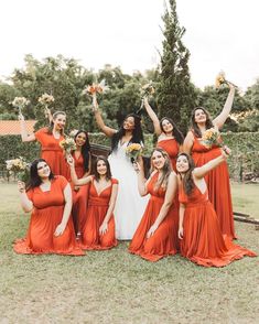 a group of women in orange dresses posing for a photo